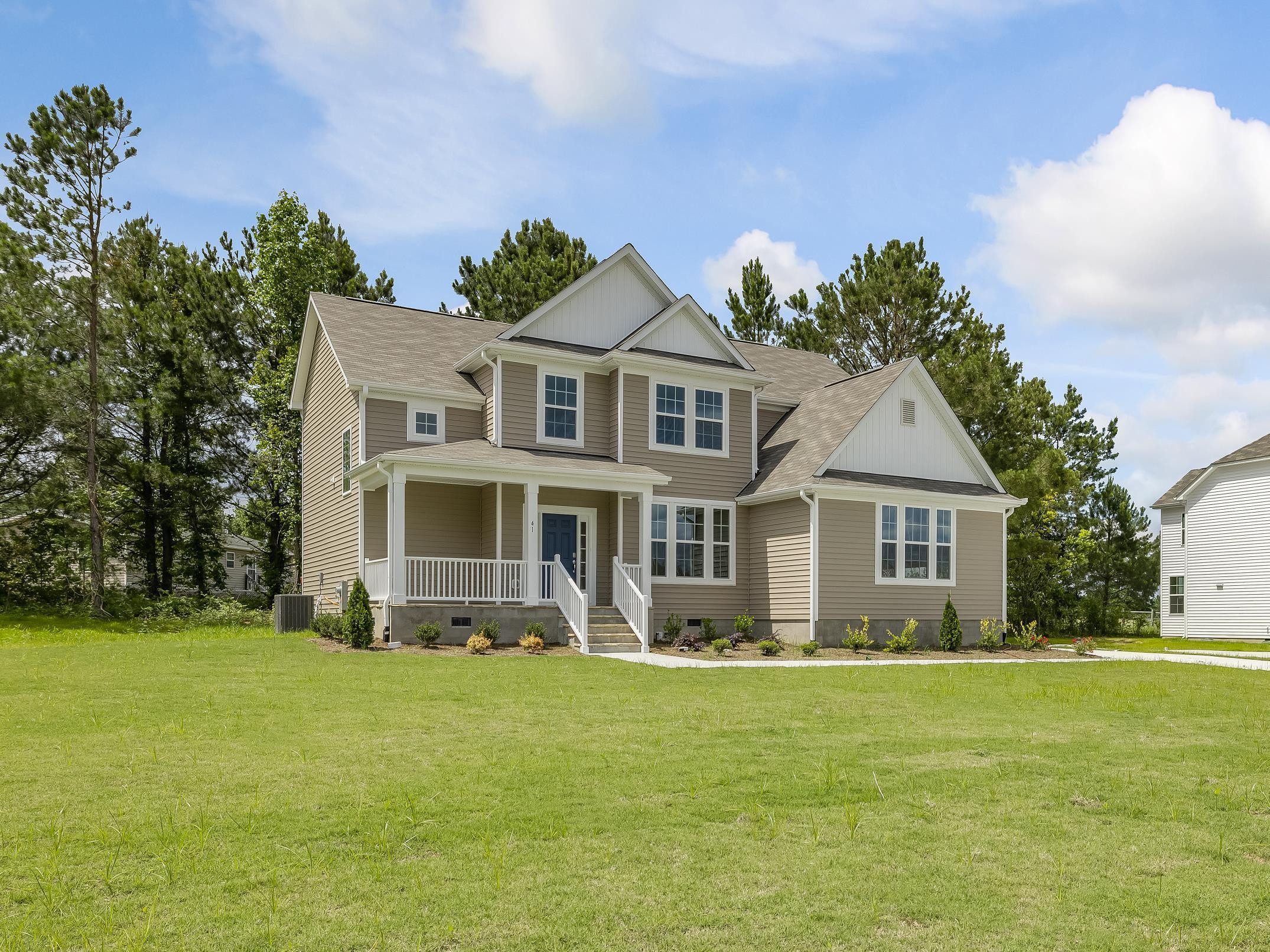 41 Two Belles Court, Unit BG 2 Angier, NC 27501 - Photo 2 of 3 a front view of a house with garden