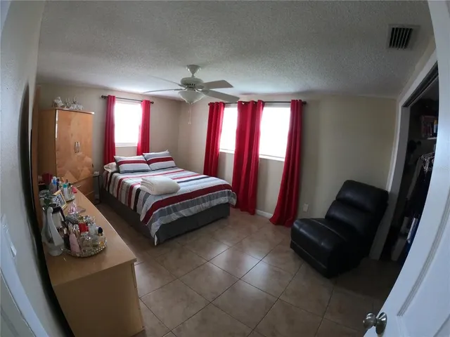 a bedroom with a bed and a mirror