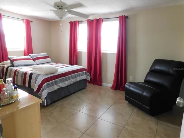 a bedroom with a bed and a chair