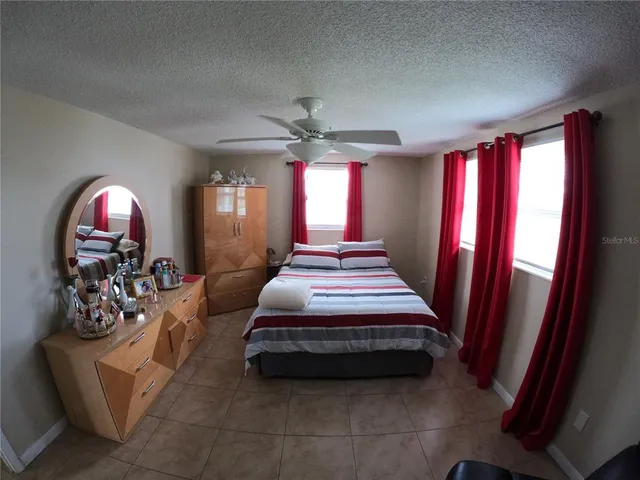 a bedroom with furniture and a large window