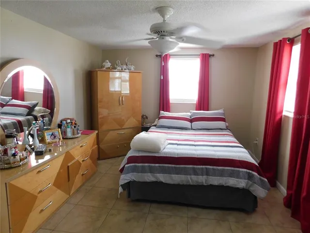 a bedroom with a bed window and dresser