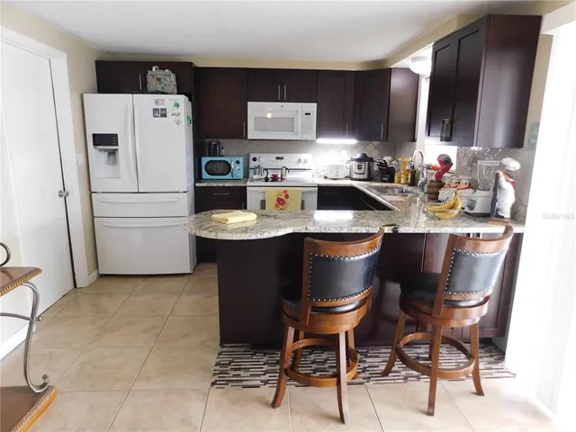a kitchen with stainless steel appliances a refrigerator and a stove top oven