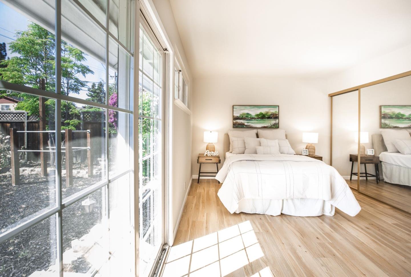 4447 Sloat Road Fremont, CA 94538 - Photo 13 of 28 a bedroom with a bed and a large window