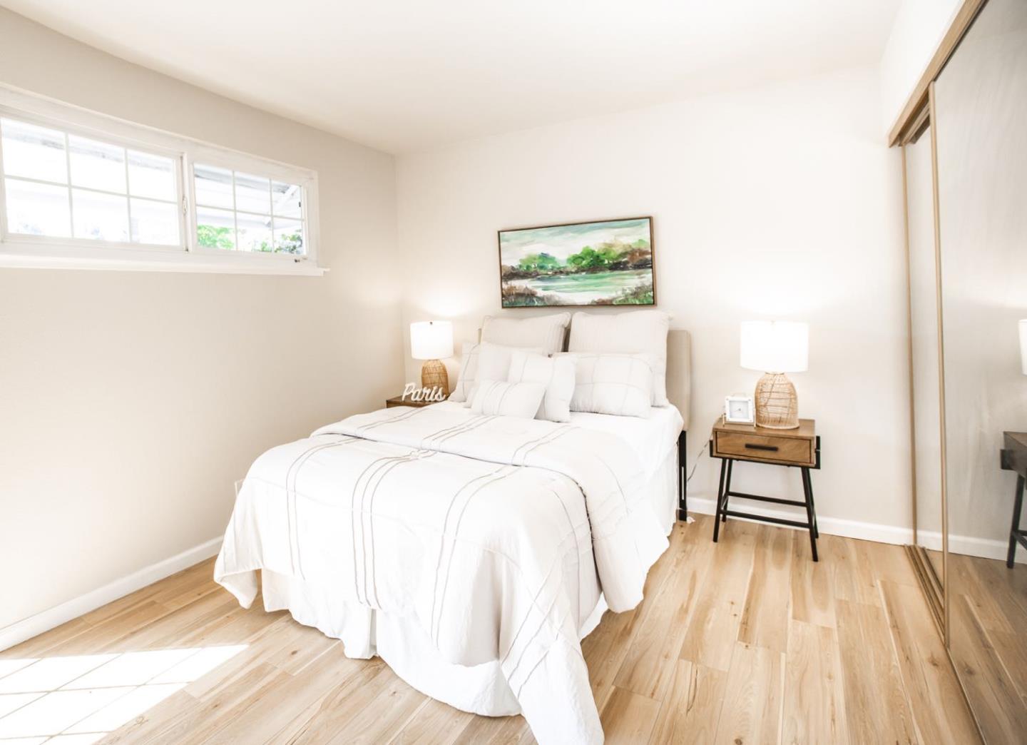 4447 Sloat Road Fremont, CA 94538 - Photo 14 of 28 a bedroom with a bed and a painting on the wall