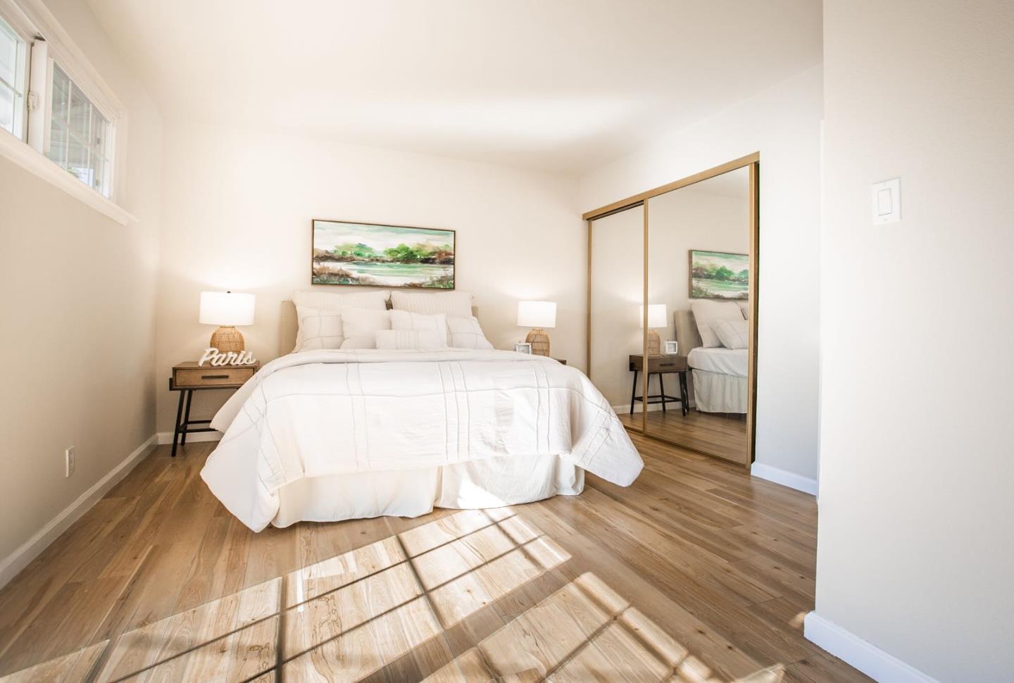 4447 Sloat Road Fremont, CA 94538 - Photo 15 of 28 a bedroom with a bed and a mirror