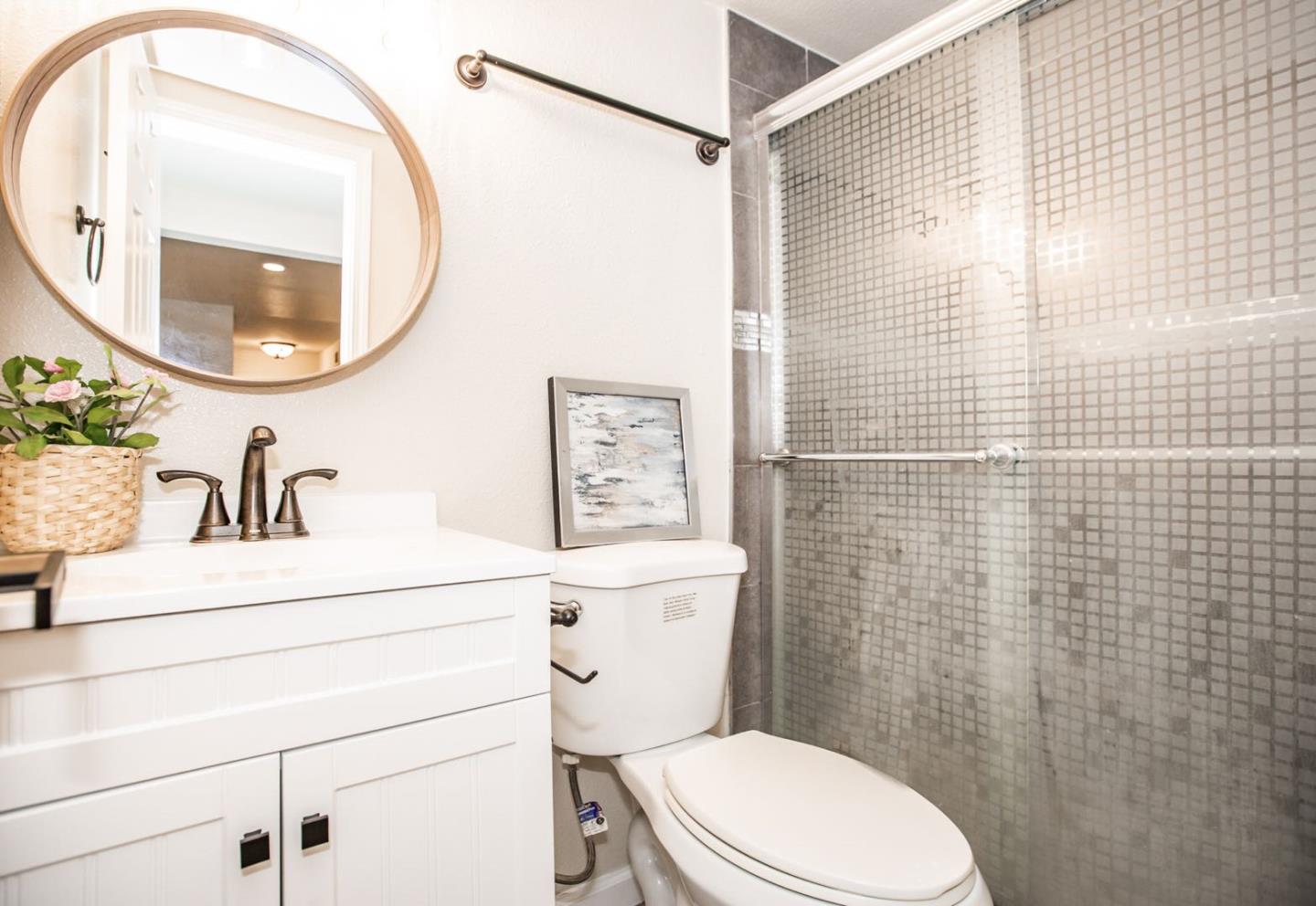 4447 Sloat Road Fremont, CA 94538 - Photo 18 of 28 a bathroom with a sink a toilet and a mirror