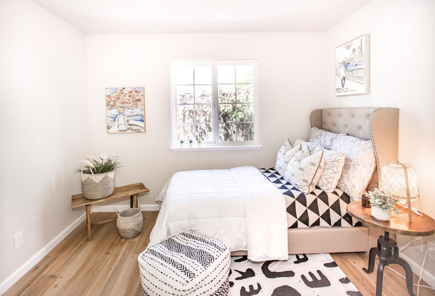 4447 Sloat Road Fremont, CA 94538 - Photo 19 of 28 a bedroom with a bed and wooden floor