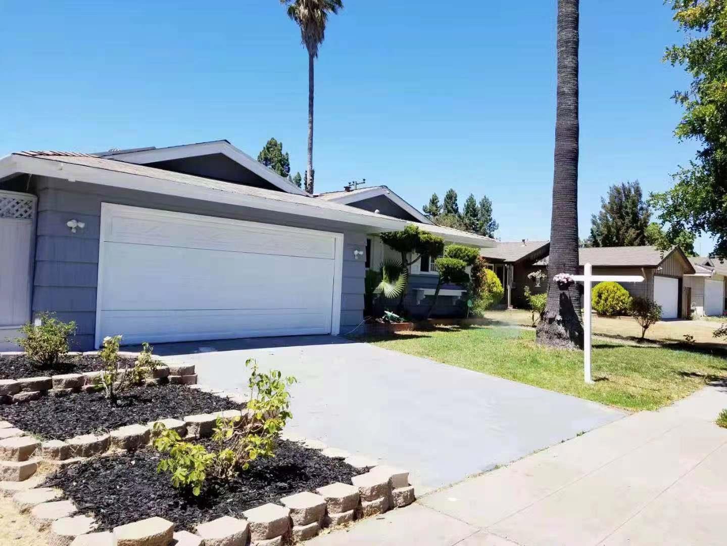4447 Sloat Road Fremont, CA 94538 - Photo 3 of 28 a front view of a house with a yard and garage