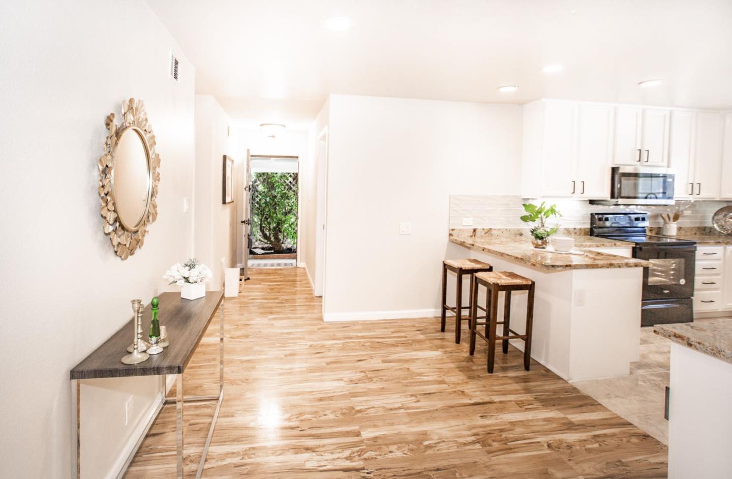 4447 Sloat Road Fremont, CA 94538 - Photo 4 of 28 a room with stainless steel appliances kitchen island granite countertop a sink and cabinets