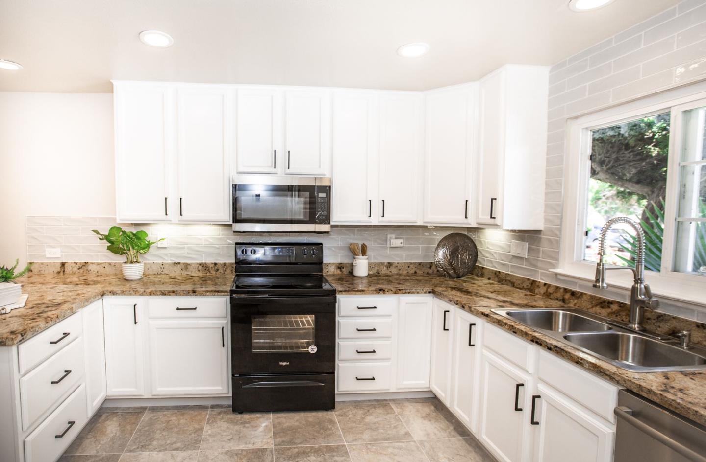 4447 Sloat Road Fremont, CA 94538 - Photo 5 of 28 a kitchen with granite countertop white cabinets white appliances and a granite counter tops
