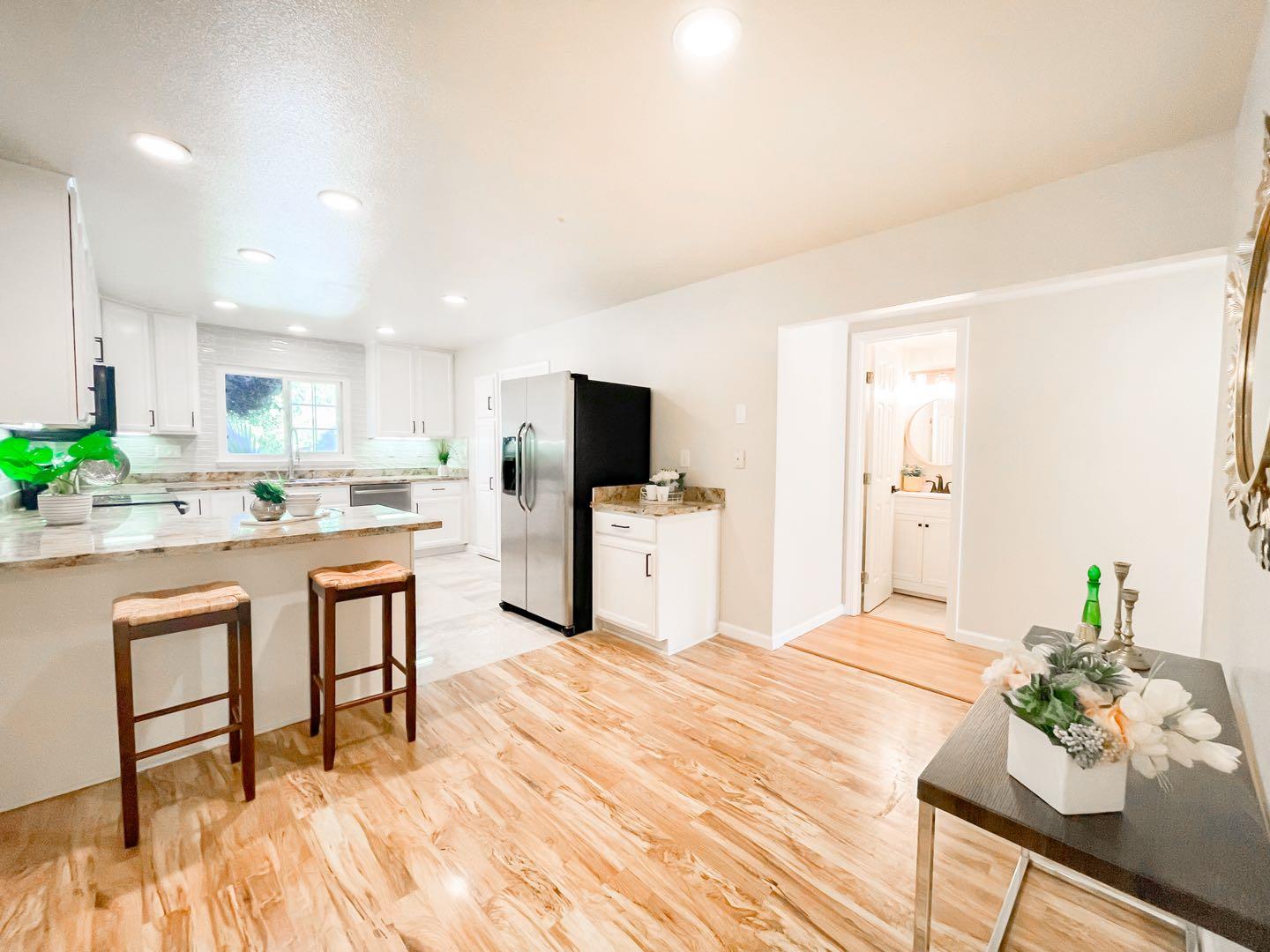 4447 Sloat Road Fremont, CA 94538 - Photo 7 of 28 a room with stainless steel appliances kitchen island granite countertop a sink and cabinets