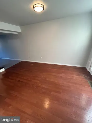 an empty room with wooden floor