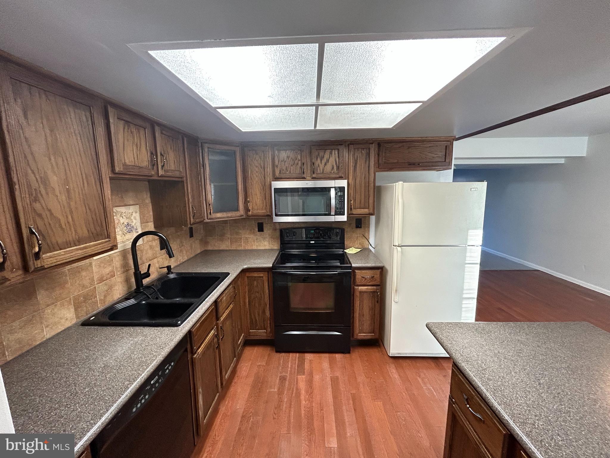 9 Radcliff Place Willingboro, NJ 08046 - Photo 5 of 13 a kitchen with granite countertop a stove a refrigerator and a sink