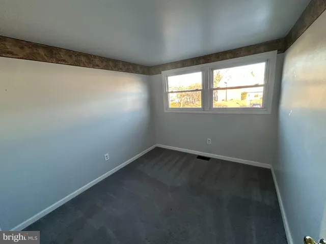 an empty room with a empty space and windows