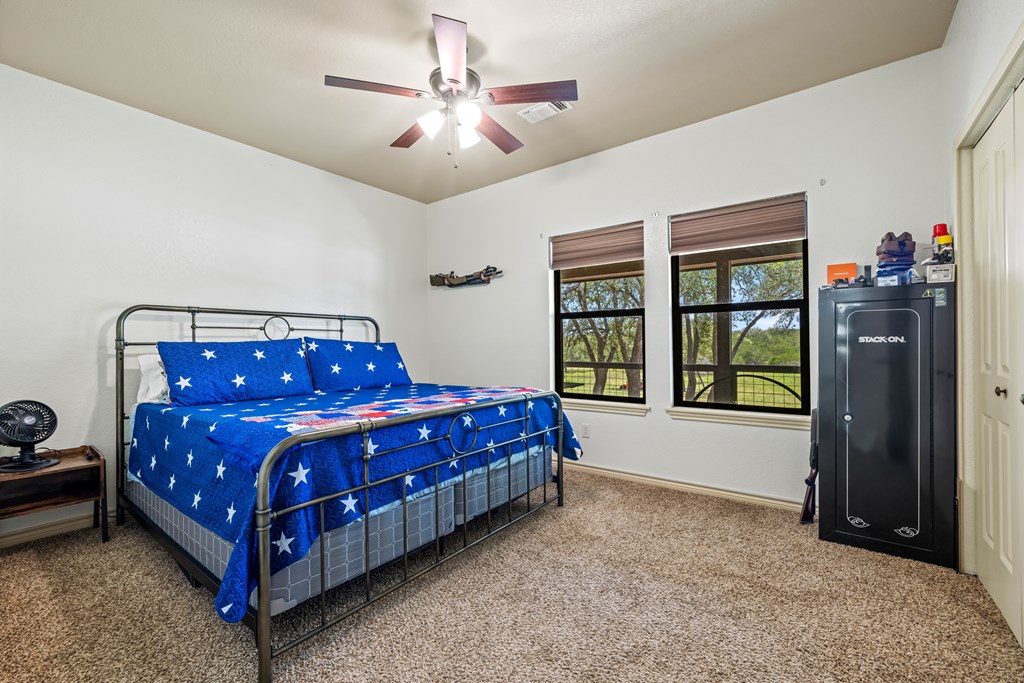 221 Coyote Trail Harper, TX 78631 - Photo 11 of 47 a bed sitting in a room next to a window