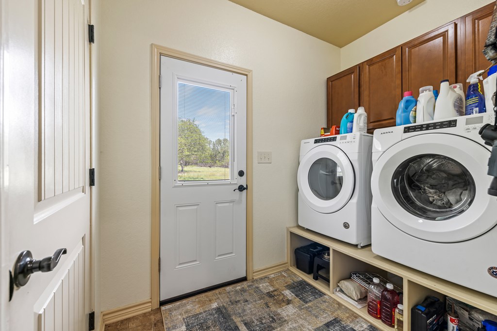 221 Coyote Trail Harper, TX 78631 - Photo 14 of 47 a utility room with dryer and washer