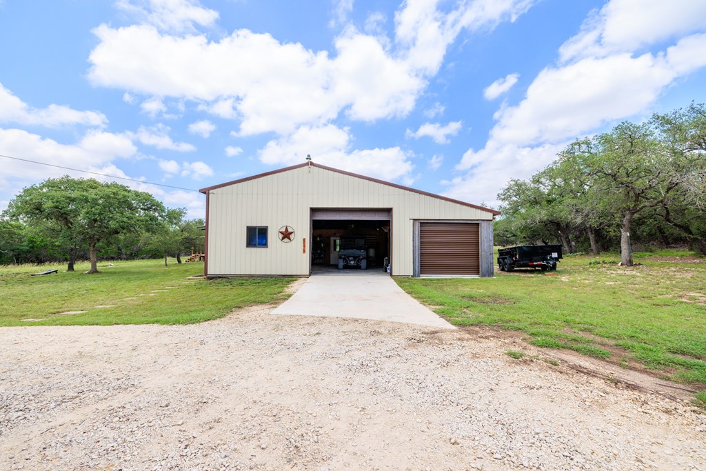 221 Coyote Trail Harper, TX 78631 - Photo 17 of 47 a front view of a house with a yard and garage