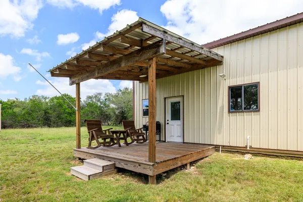 a view of a patio with a table chairs and backyard