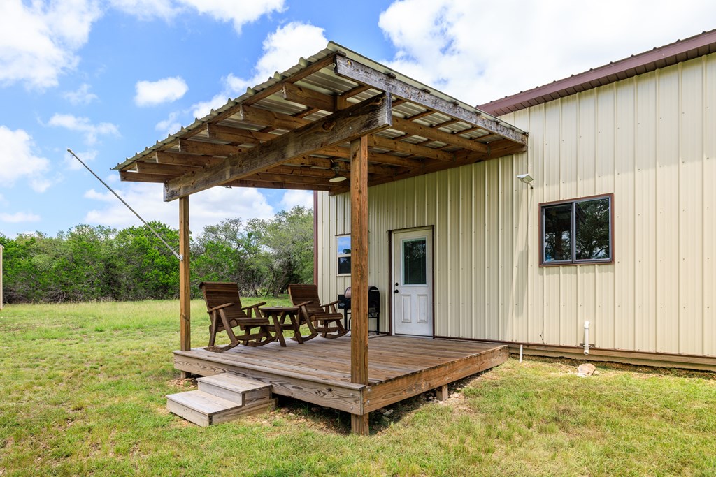 221 Coyote Trail Harper, TX 78631 - Photo 18 of 47 a view of a patio with a table chairs and backyard