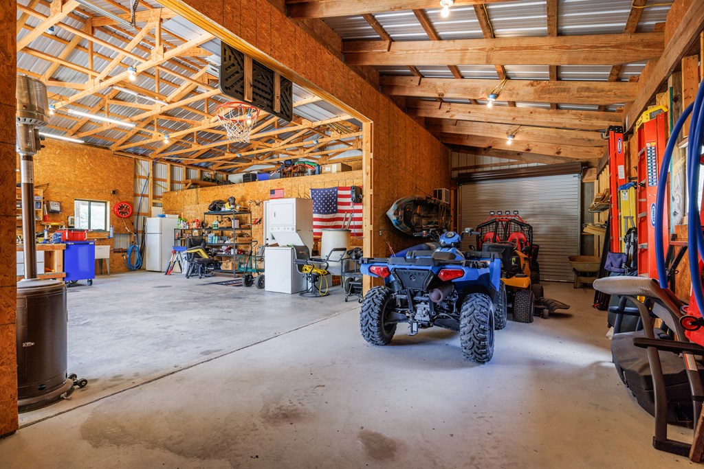 221 Coyote Trail Harper, TX 78631 - Photo 29 of 47 a view of a garage with storage