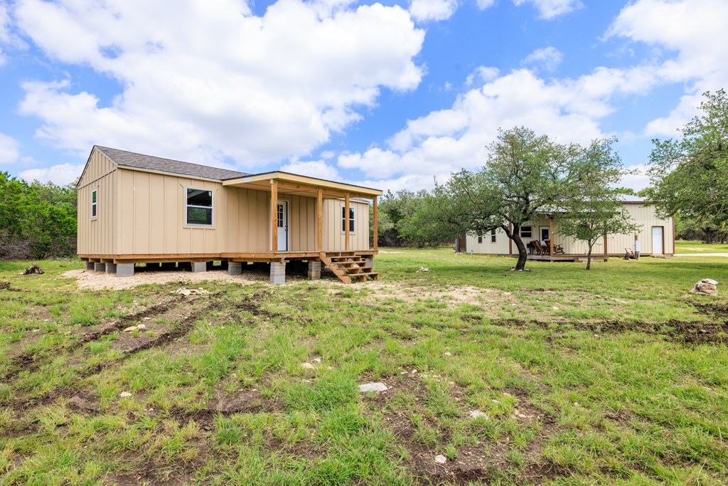 221 Coyote Trail Harper, TX 78631 - Photo 38 of 47 a view of a house with yard and tree s