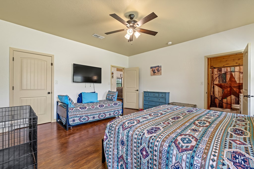 221 Coyote Trail Harper, TX 78631 - Photo 9 of 47 a bedroom with two beds and a flat screen tv