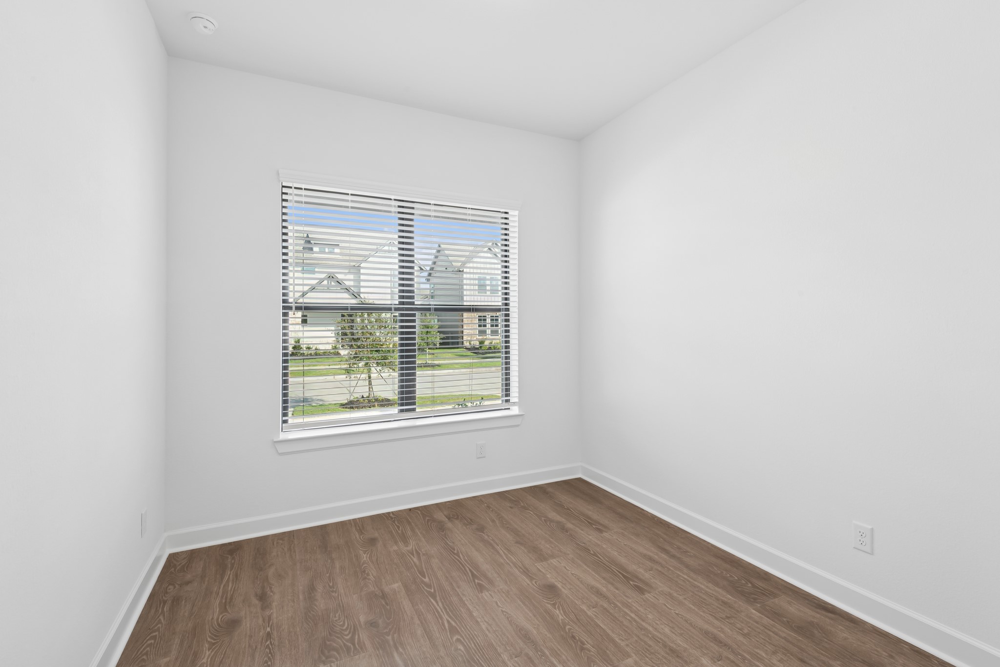 5510 Orangery Lane Manvel, TX 77578 - Photo 13 of 48 an empty room with wooden floor and windows