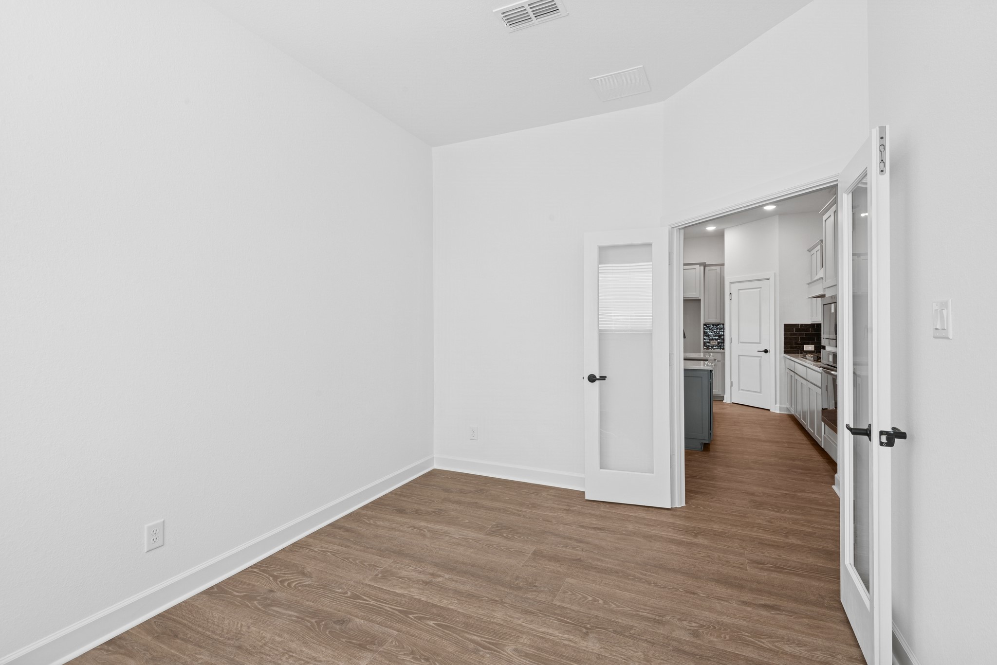 5510 Orangery Lane Manvel, TX 77578 - Photo 20 of 48 a view of an empty room with wooden floor and a bathroom