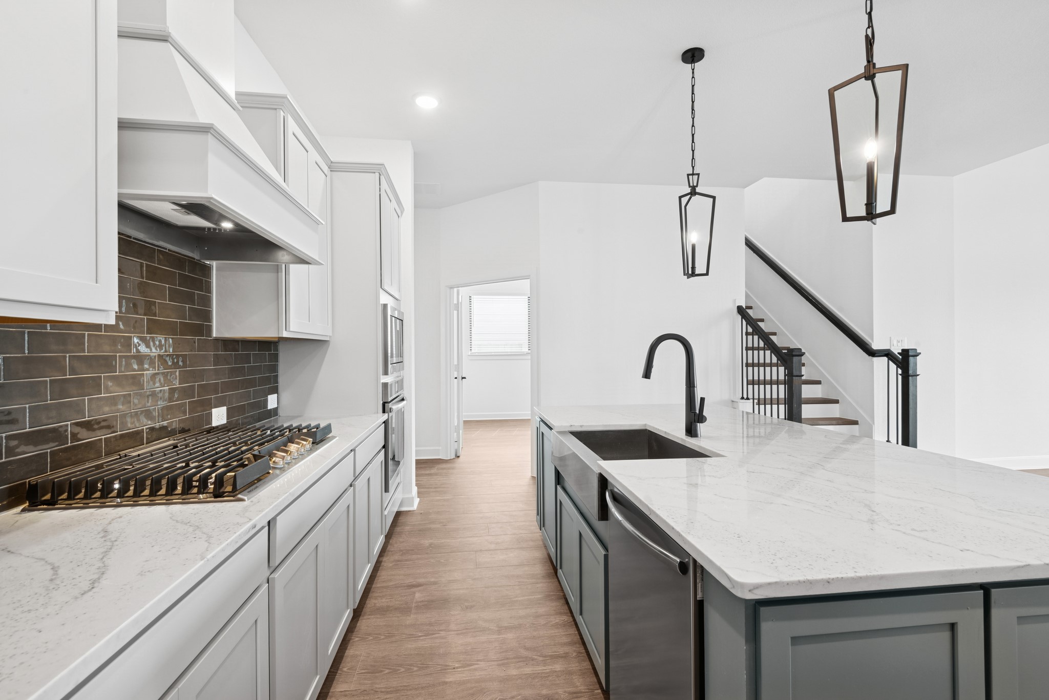 5510 Orangery Lane Manvel, TX 77578 - Photo 25 of 48 a kitchen with stainless steel appliances granite countertop a sink a stove and a wooden floors