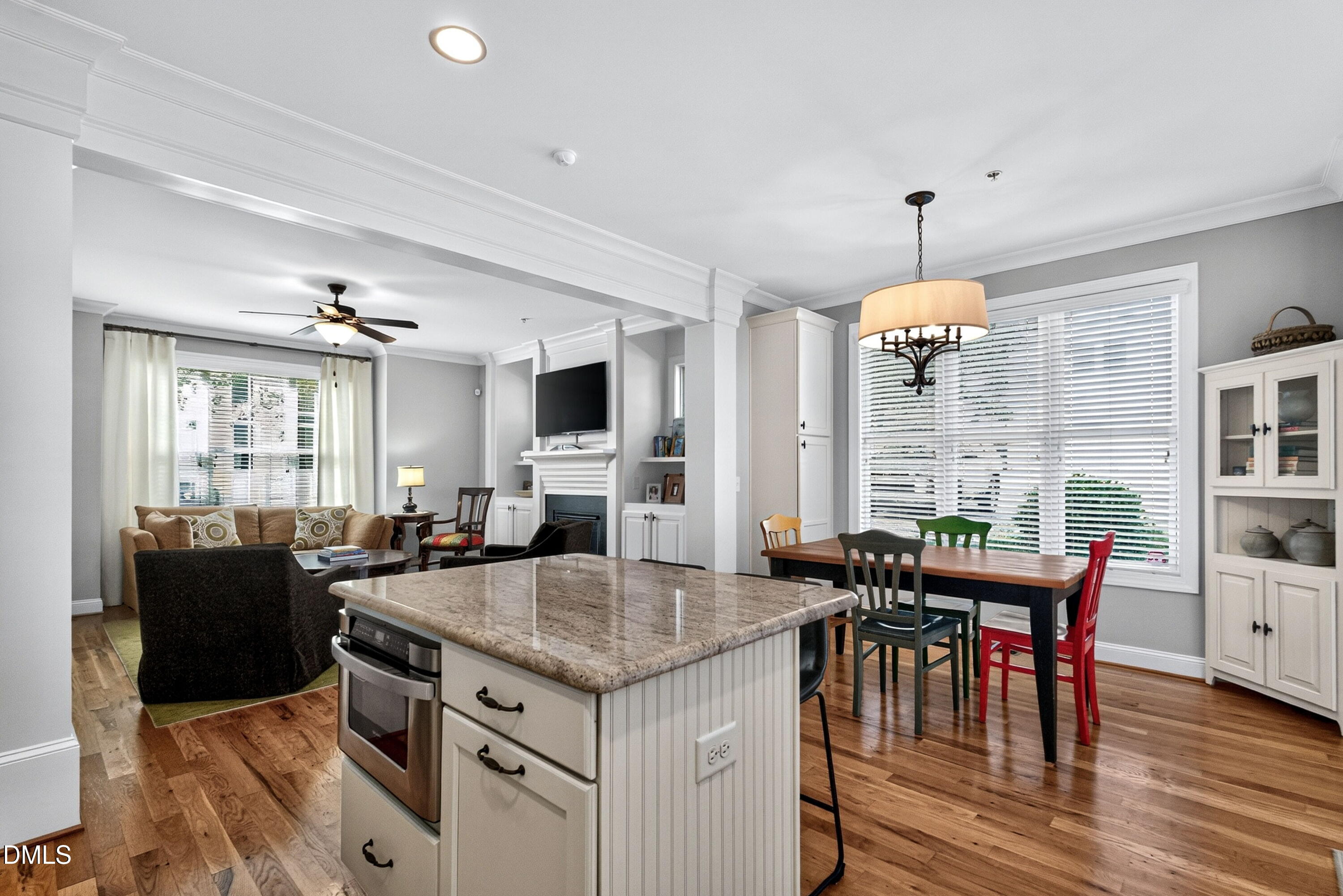 2745 Oberlin Road, Unit 103 Raleigh, NC 27608 - Photo 13 of 23 an open kitchen with granite countertop a stove dining table and chairs
