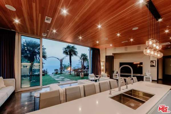 a living room with patio furniture and a fireplace