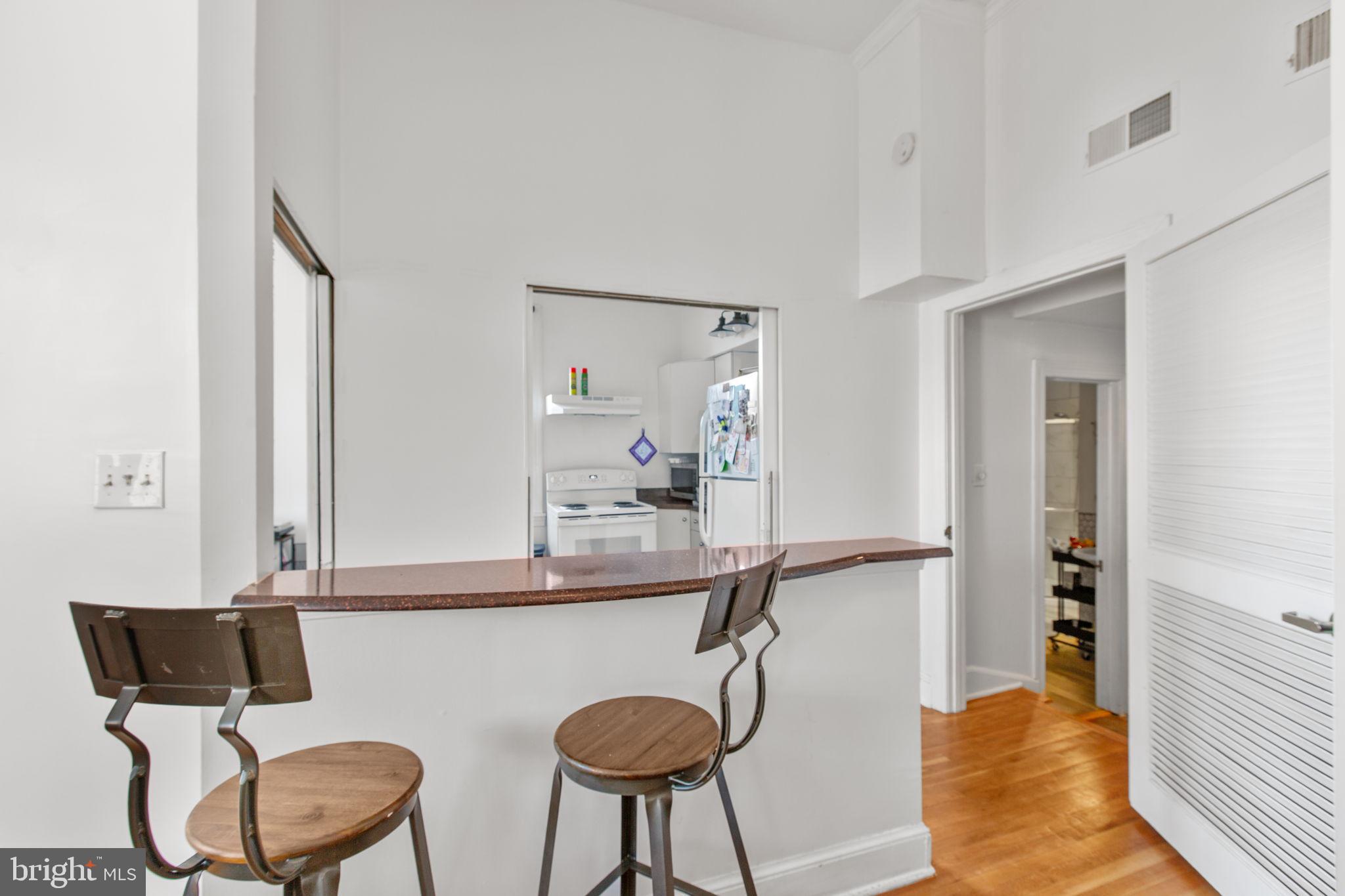 809 Caroline Street Fredericksburg, VA 22401 - Photo 5 of 12 Bar between kitchen and living rm adds flexibility