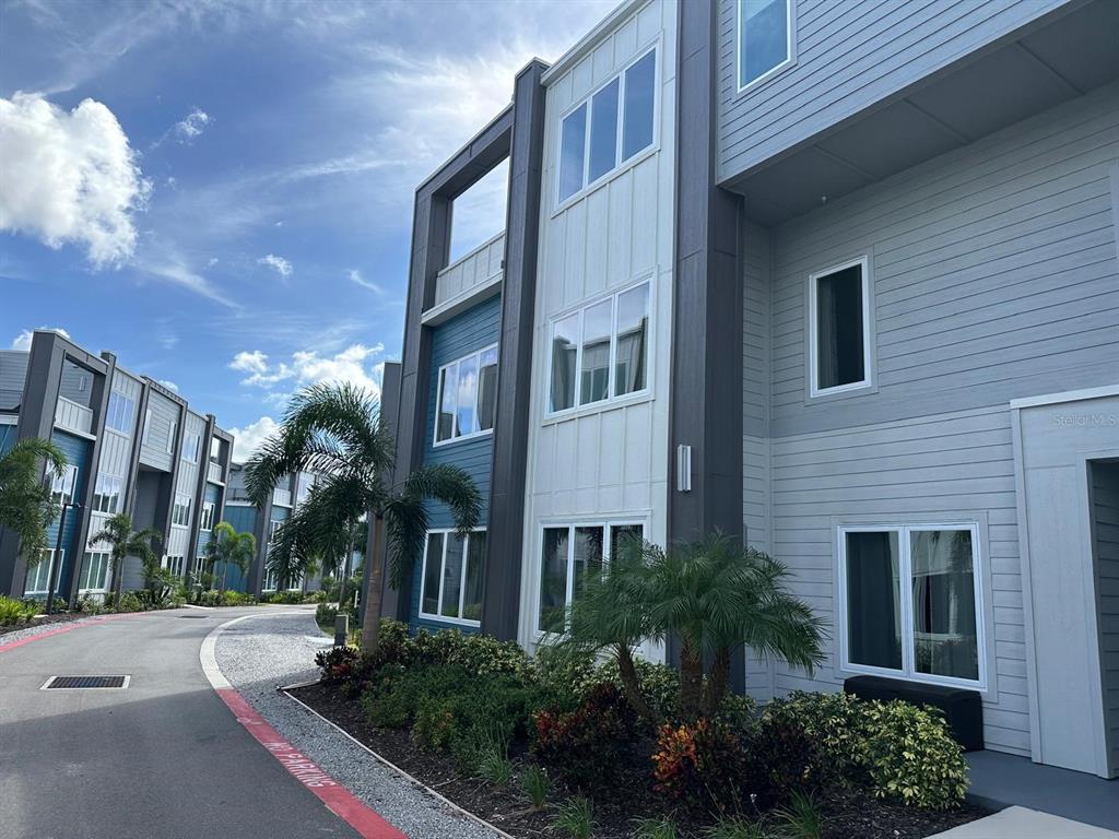 7770 Sandy Ridge Drive, Unit 126 Reunion, FL 34747 - Photo 1 of 33 a view of a building next to a yard