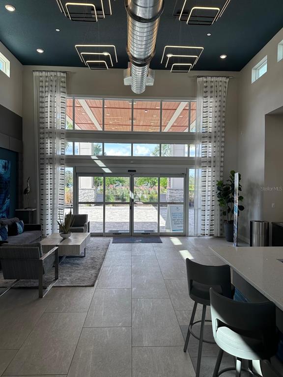7770 Sandy Ridge Drive, Unit 126 Reunion, FL 34747 - Photo 20 of 33 a living room with furniture and a large window