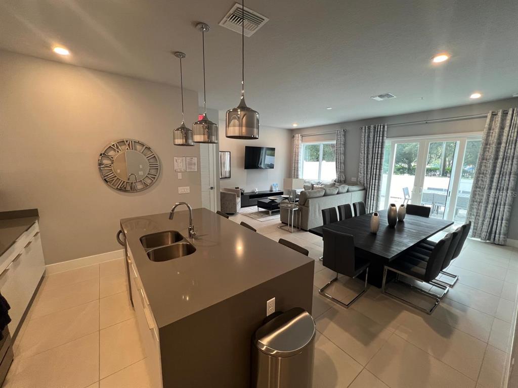 7770 Sandy Ridge Drive, Unit 126 Reunion, FL 34747 - Photo 2 of 33 a living room with furniture a flat screen tv and a window