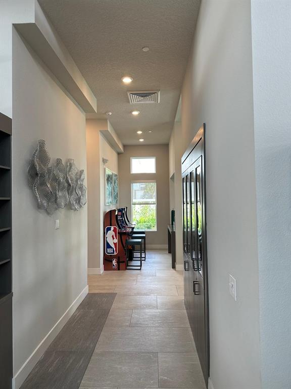 7770 Sandy Ridge Drive, Unit 126 Reunion, FL 34747 - Photo 21 of 33 a view of a hallway with couches and dining table