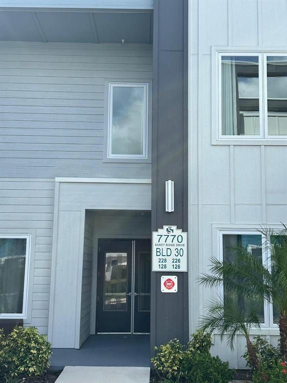 7770 Sandy Ridge Drive, Unit 126 Reunion, FL 34747 - Photo 30 of 33 a front view of a house with a yard