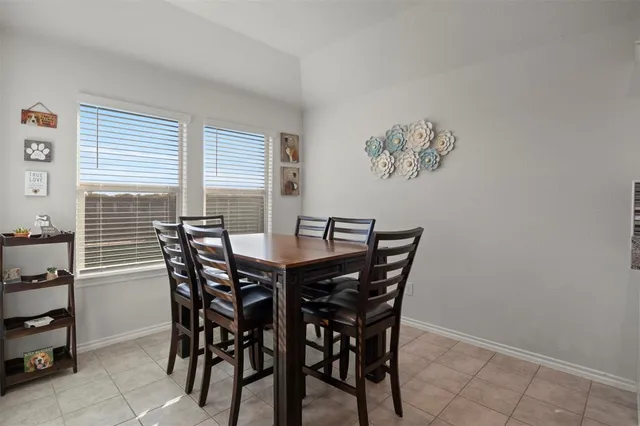 a view of a dining room with furniture and window