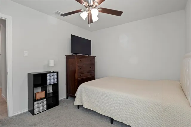 a bedroom with a bed and a television