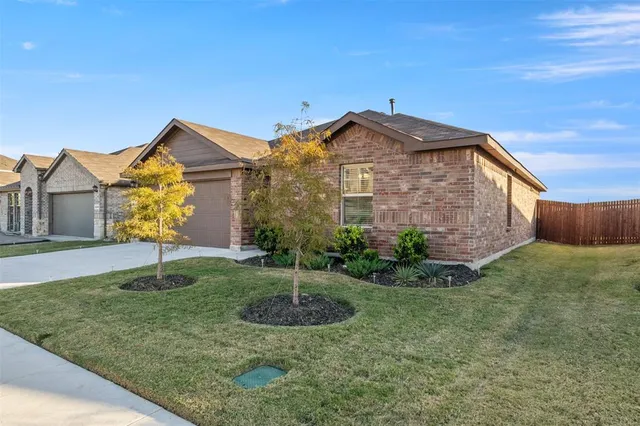 a view of a brick house with a yard