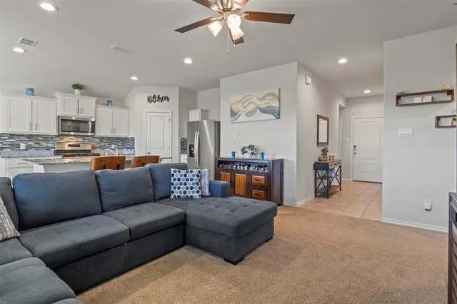 a living room with furniture and kitchen view