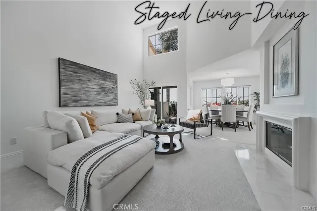 a living room with furniture a fireplace and gym equipment