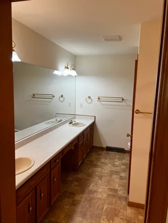 a large bathroom with a double vanity sink and a mirror