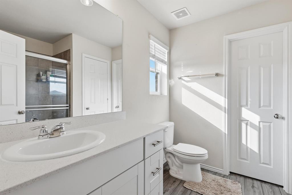 16041 Pious Drive Haslet, TX 76052 - Photo 17 of 36 Full bathroom featuring vanity, light wood-style floors, and a shower stall