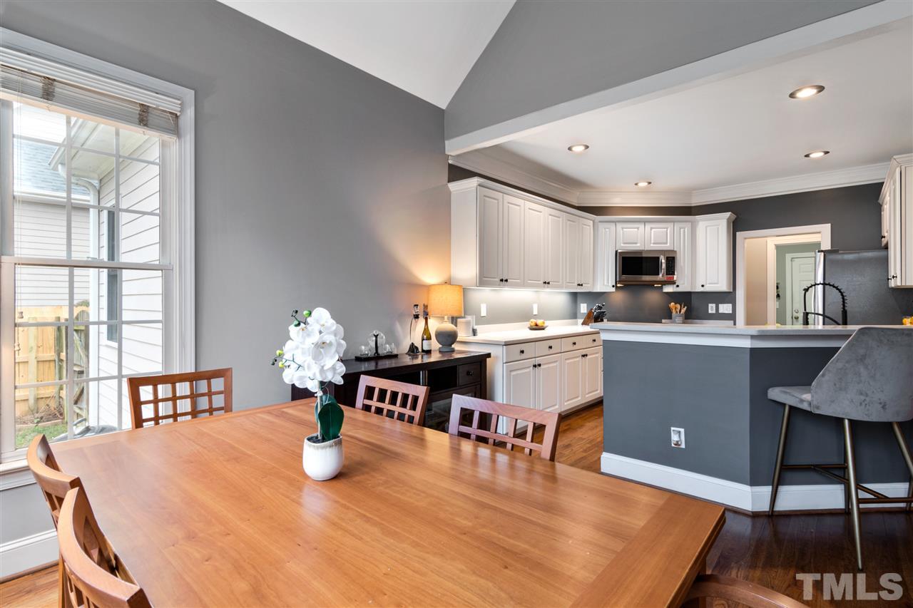 2408 Carruthers Court Raleigh, NC 27615 - Photo 12 of 30 a room with stainless steel appliances kitchen island granite countertop a dining table chairs and granite counter tops