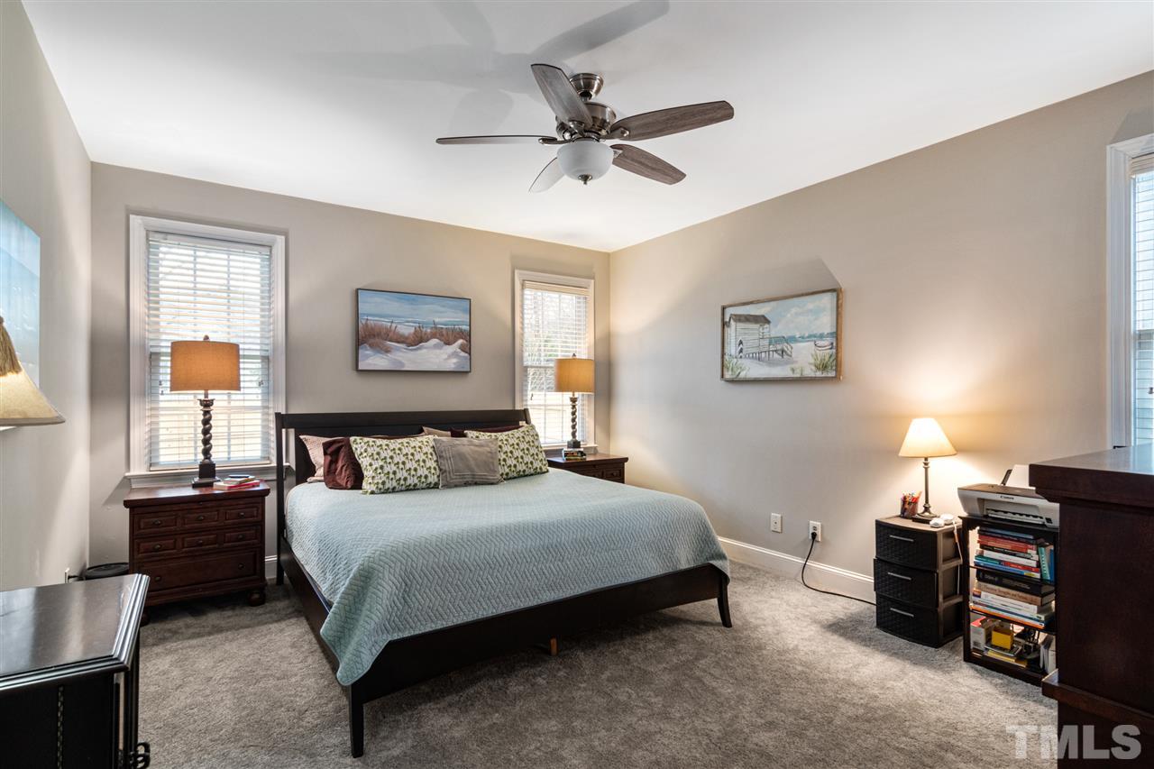 2408 Carruthers Court Raleigh, NC 27615 - Photo 14 of 30 a bedroom with a bed and a chandelier