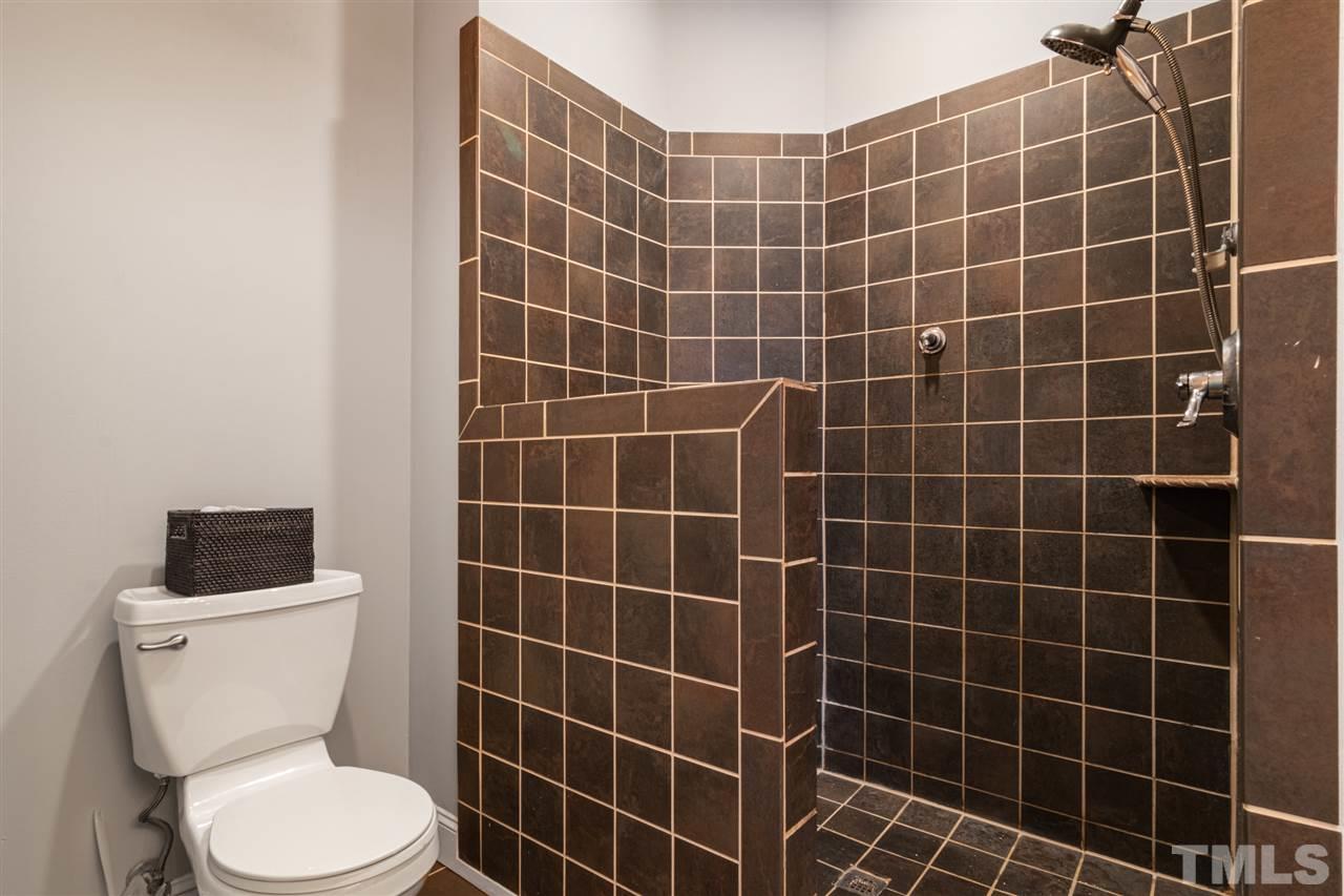 2408 Carruthers Court Raleigh, NC 27615 - Photo 16 of 30 a bathroom with a toilet sink and blue shower