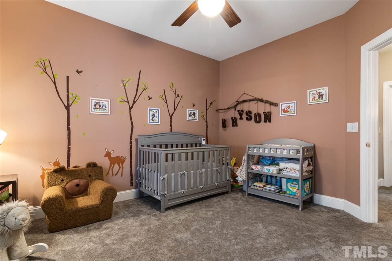 2408 Carruthers Court Raleigh, NC 27615 - Photo 18 of 30 a bedroom with furniture and a baby crib
