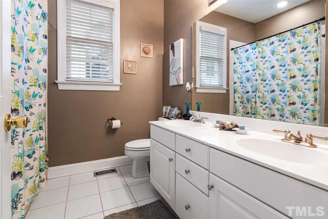 2408 Carruthers Court Raleigh, NC 27615 - Photo 19 of 30 a bathroom with a sink a toilet and a mirror