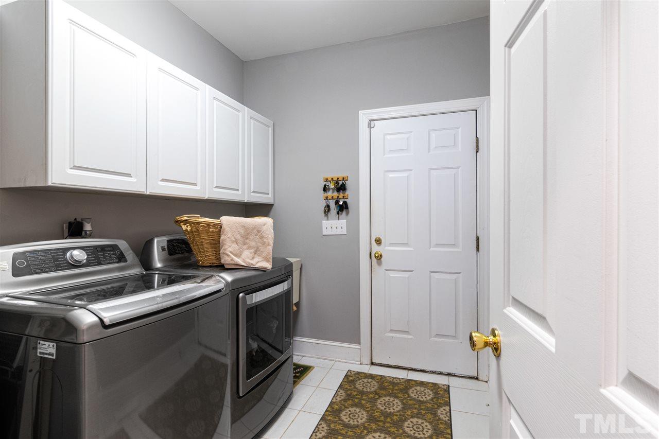 2408 Carruthers Court Raleigh, NC 27615 - Photo 21 of 30 a kitchen with a stove and a refrigerator